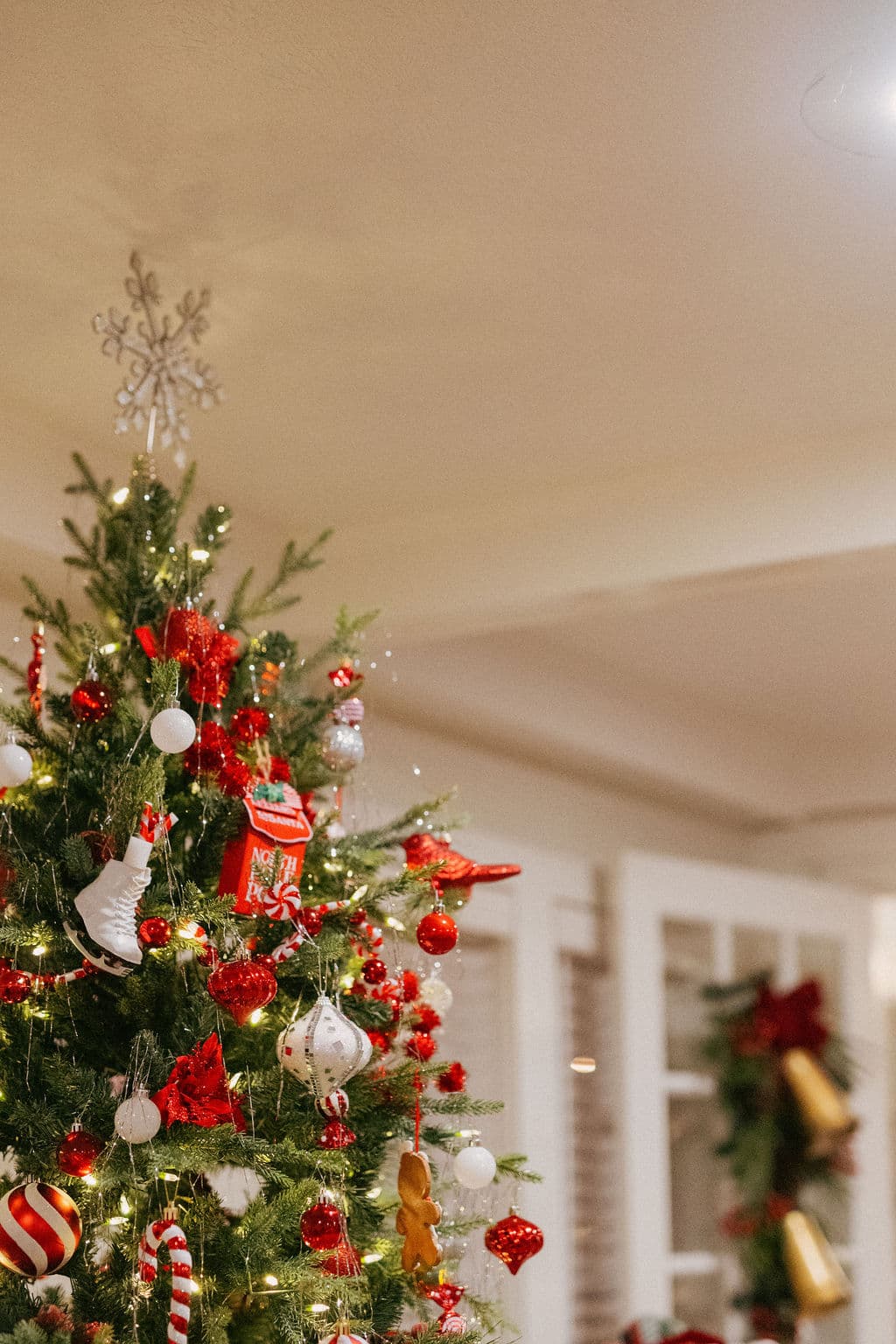 A beautifully decorated Christmas tree adorned with red and white ornaments and lights.